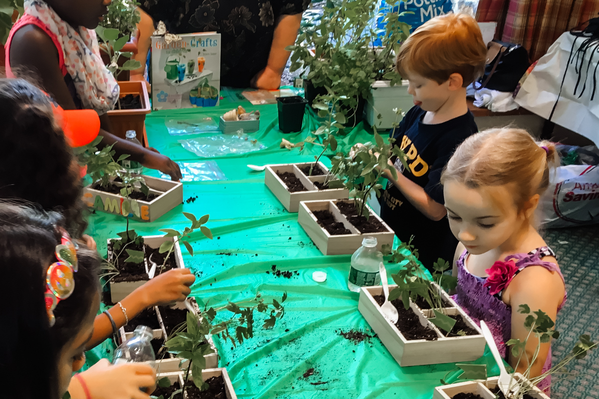 VBS Participants planting an her garden in God's soil.